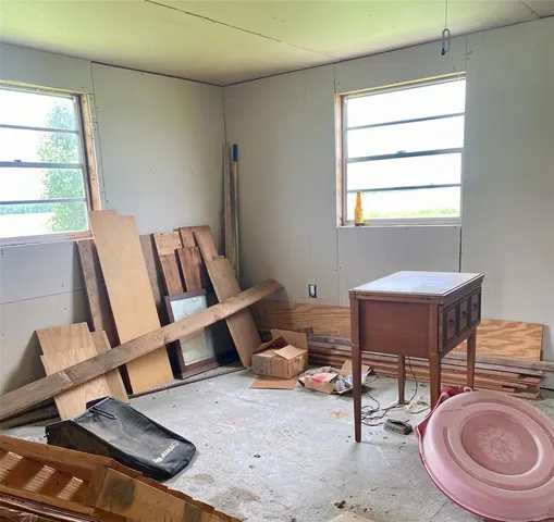 a living room with furniture a rug and a window