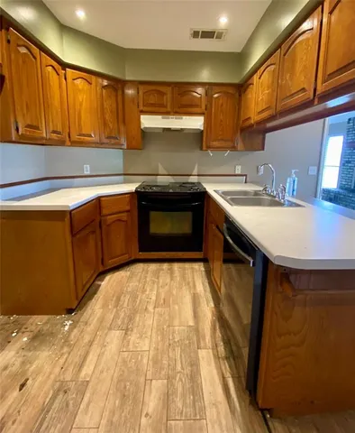 a kitchen with stainless steel appliances granite countertop a sink stove and cabinets