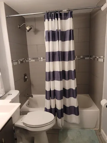 a white toilet sitting next to a bathroom sink
