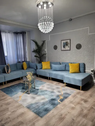 a living room with furniture and a chandelier