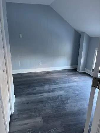 a view of wooden floor and windows in a room