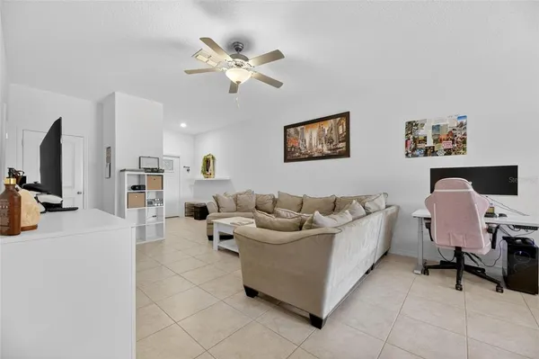 a kitchen with stainless steel appliances kitchen island granite countertop a refrigerator and a dining table