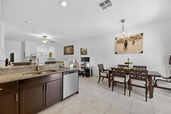 a kitchen with kitchen island granite countertop wooden cabinets stainless steel appliances and a counter space