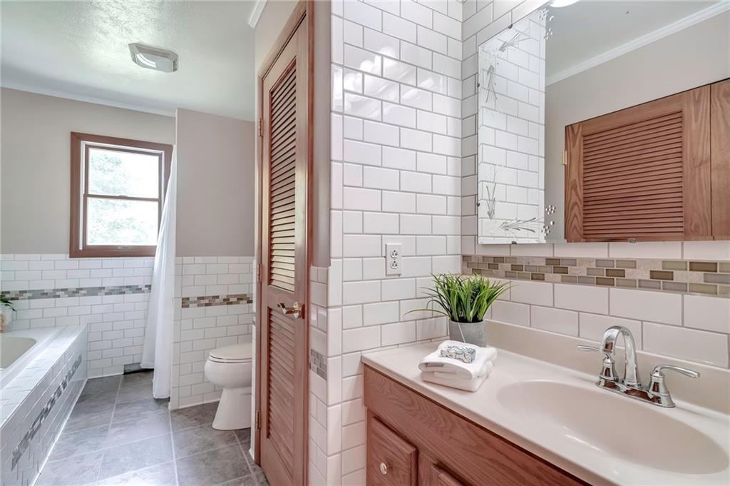 563 Leeper Road Georgetown, PA 15043 - Photo 11 of 25 Gorgeous updated main floor full bath with custom tile-work, jetted tub, walk in shower, large linen closet creating a spa-like experience.