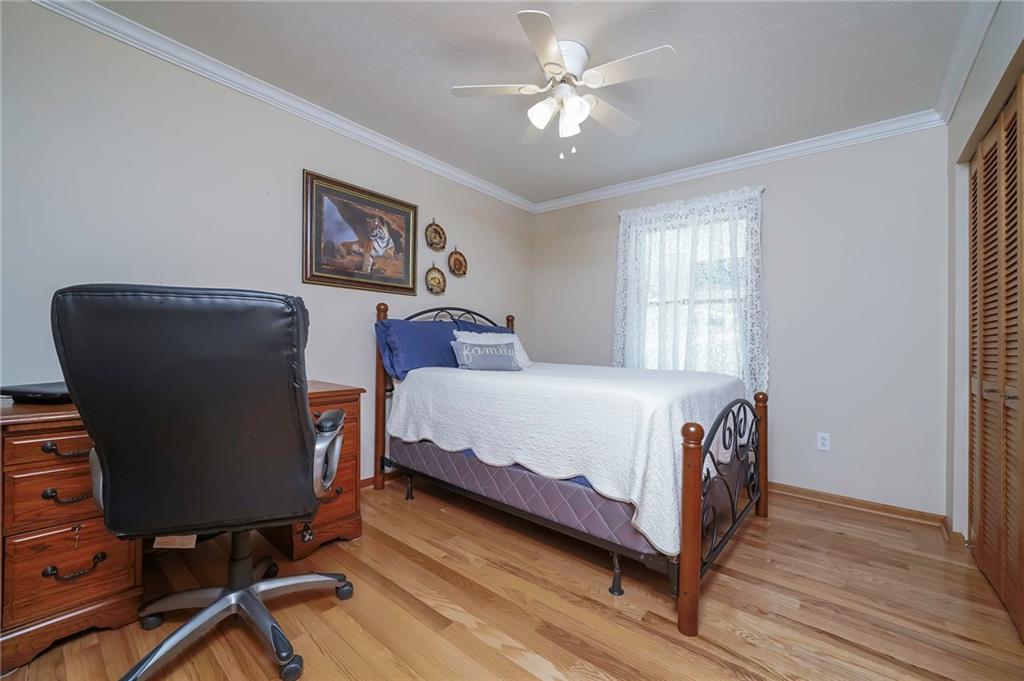 563 Leeper Road Georgetown, PA 15043 - Photo 13 of 25 Guest Bedroom features crown molding, ceiling fan, immaculate hardwoods, and double closets for all your storage needs.