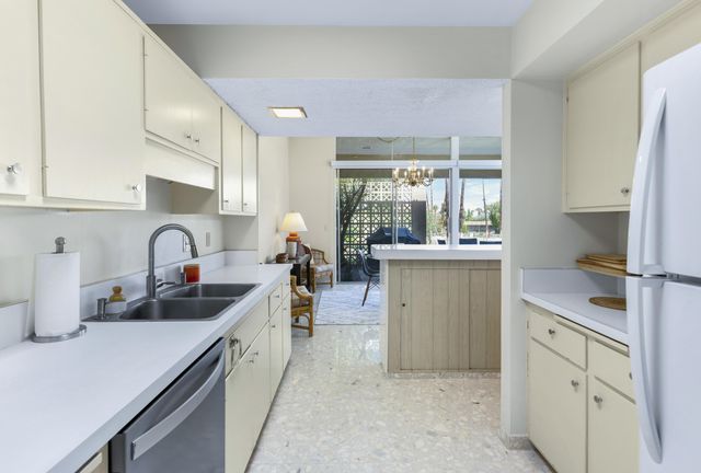 a kitchen with sink a stove and cabinets