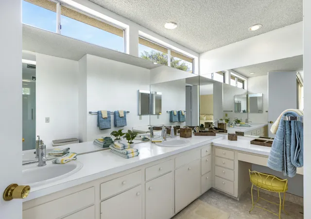 a bathroom with a sink double vanity and mirror