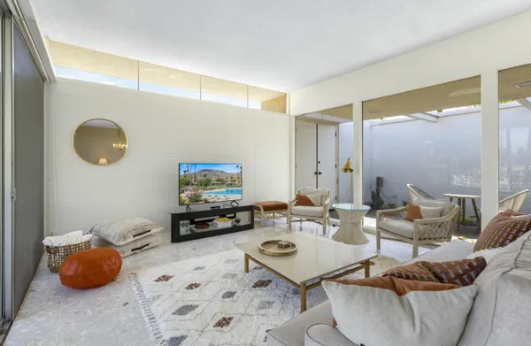 a living room with furniture and a flat screen tv