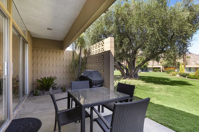 a view of backyard with seating area and green space