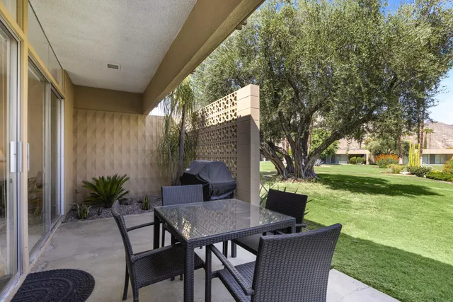 a view of backyard with seating area and green space