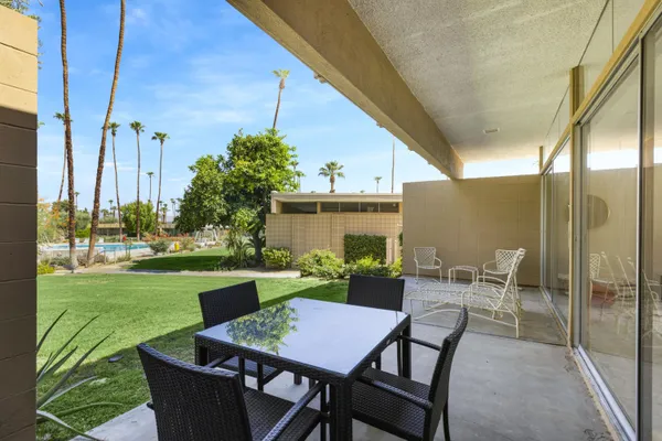 a view of a patio with table and chairs and potted plants