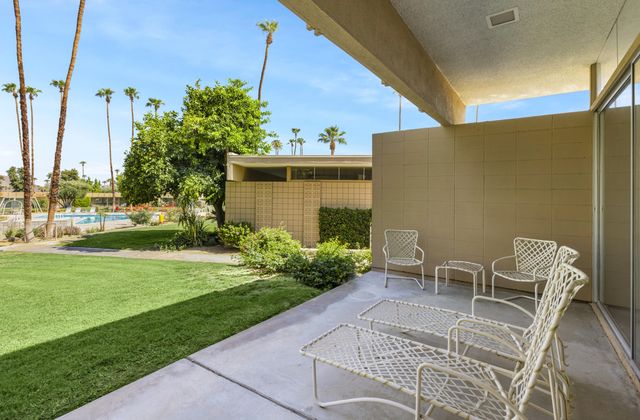 a view of a patio with table and chairs and potted plants