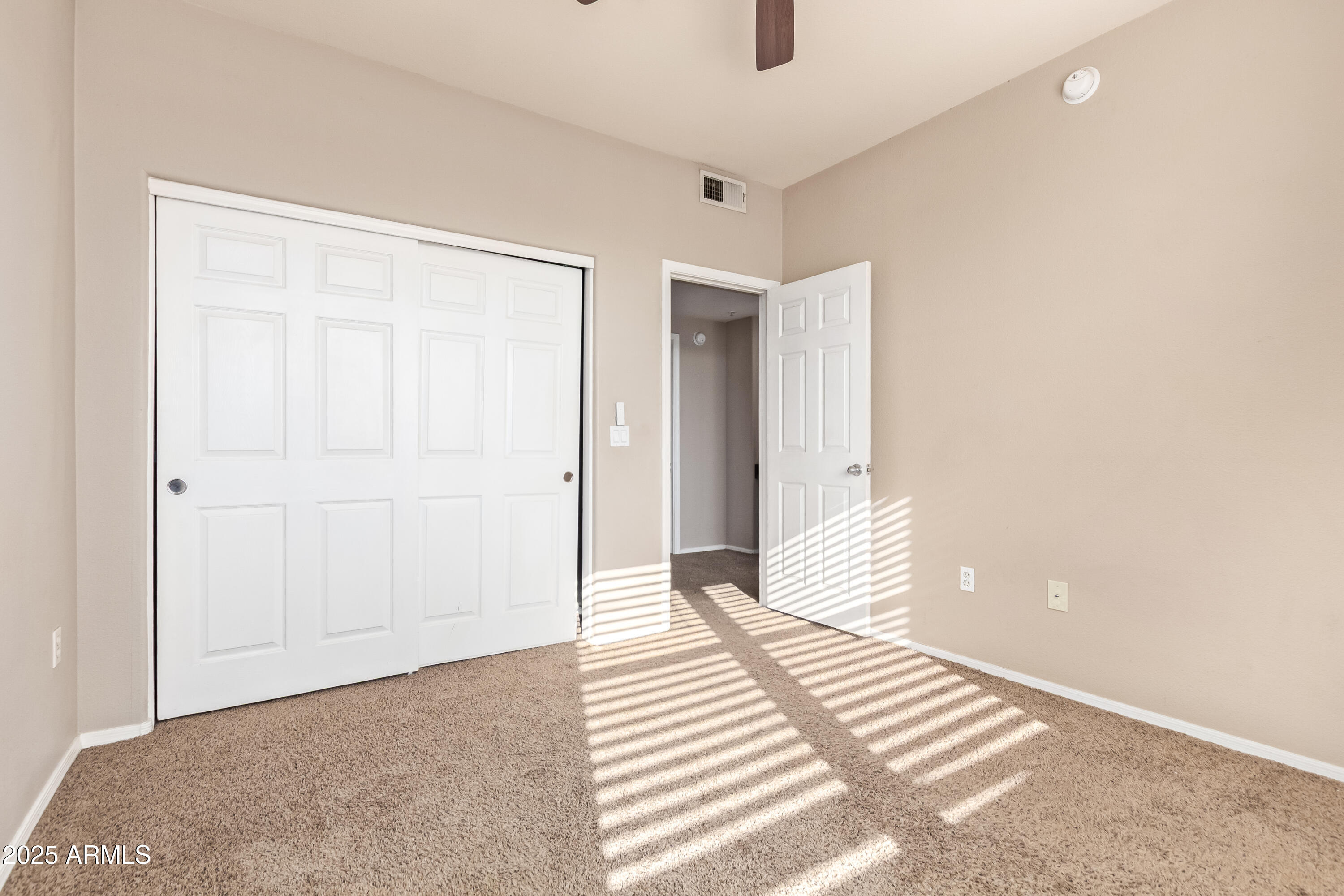 19777 North 76th Street, Unit 1337 Scottsdale, AZ 85255 - Photo 15 of 33 a bedroom with a bed and wooden floor