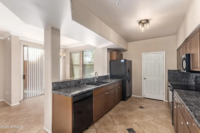 a kitchen with granite countertop a sink and a counter top space