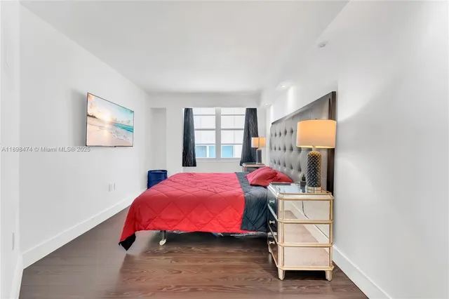 a bedroom with a bed and a potted plant