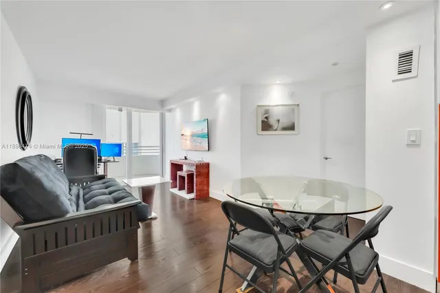 a living room with furniture a flat screen tv and a large window