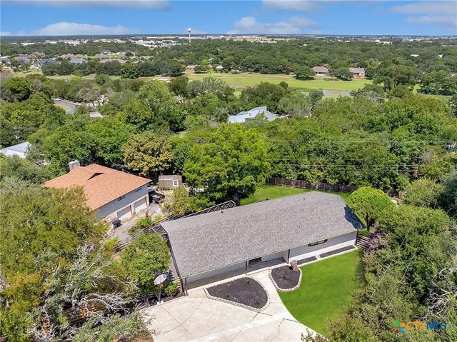 an aerial view of a house with a yard