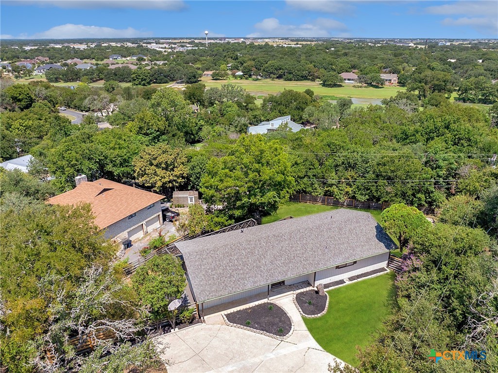 an aerial view of a house with a yard