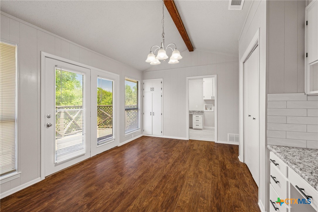 1120 Old Mill Road Salado, TX 76571 - Photo 15 of 42 a view of an empty room with wooden floor and a window