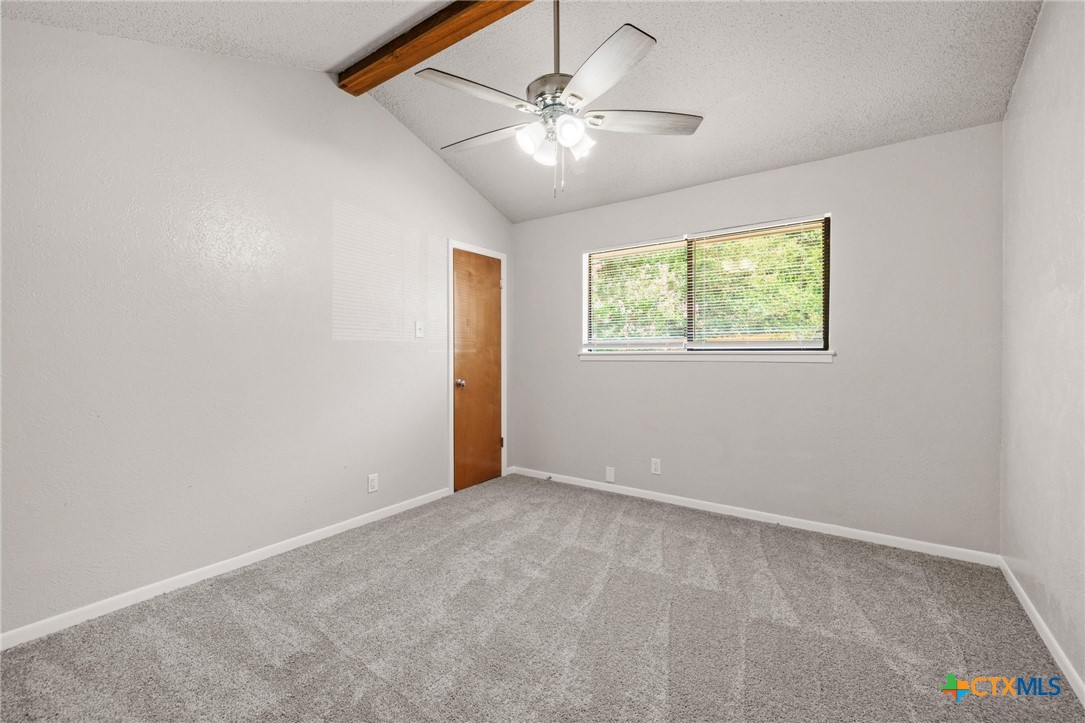 1120 Old Mill Road Salado, TX 76571 - Photo 21 of 42 an empty room with windows and fan