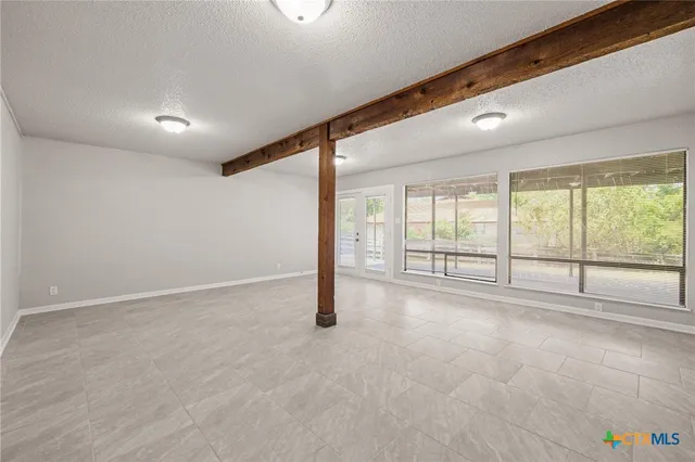 a front view of house with yard and trees in the background