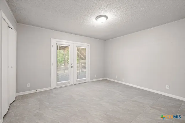 an aerial view of residential houses with outdoor space and trees