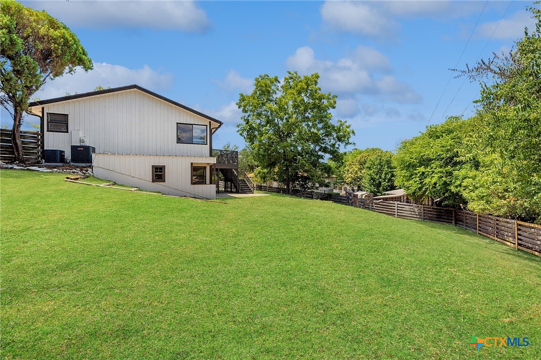 1120 Old Mill Road Salado, TX 76571 - Photo 36 of 42 a front view of house with yard and trees in the background