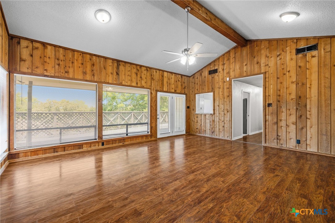 1120 Old Mill Road Salado, TX 76571 - Photo 10 of 42 a view of an empty room with wooden floor and a window