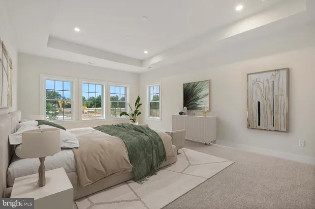 a bedroom with a large bed and a flat screen tv