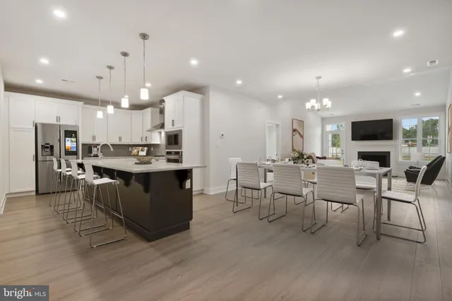 a large kitchen with a table and chairs