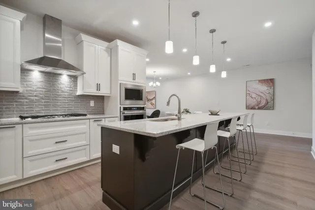 a kitchen with a sink stainless steel appliances and cabinets