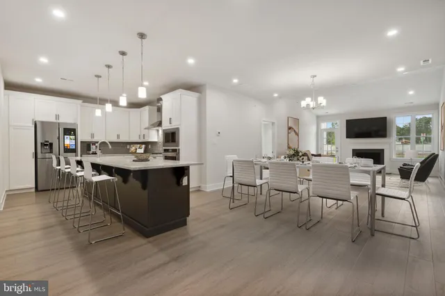 a large kitchen with a table and chairs