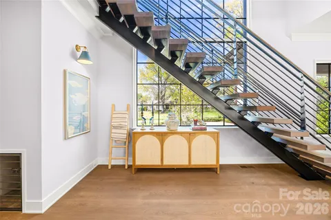 a living room with furniture a flat screen tv and a large window