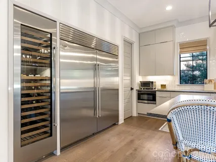 a kitchen with a refrigerator and a sink