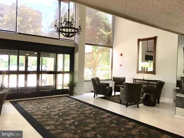 a living room with fireplace furniture and a large window