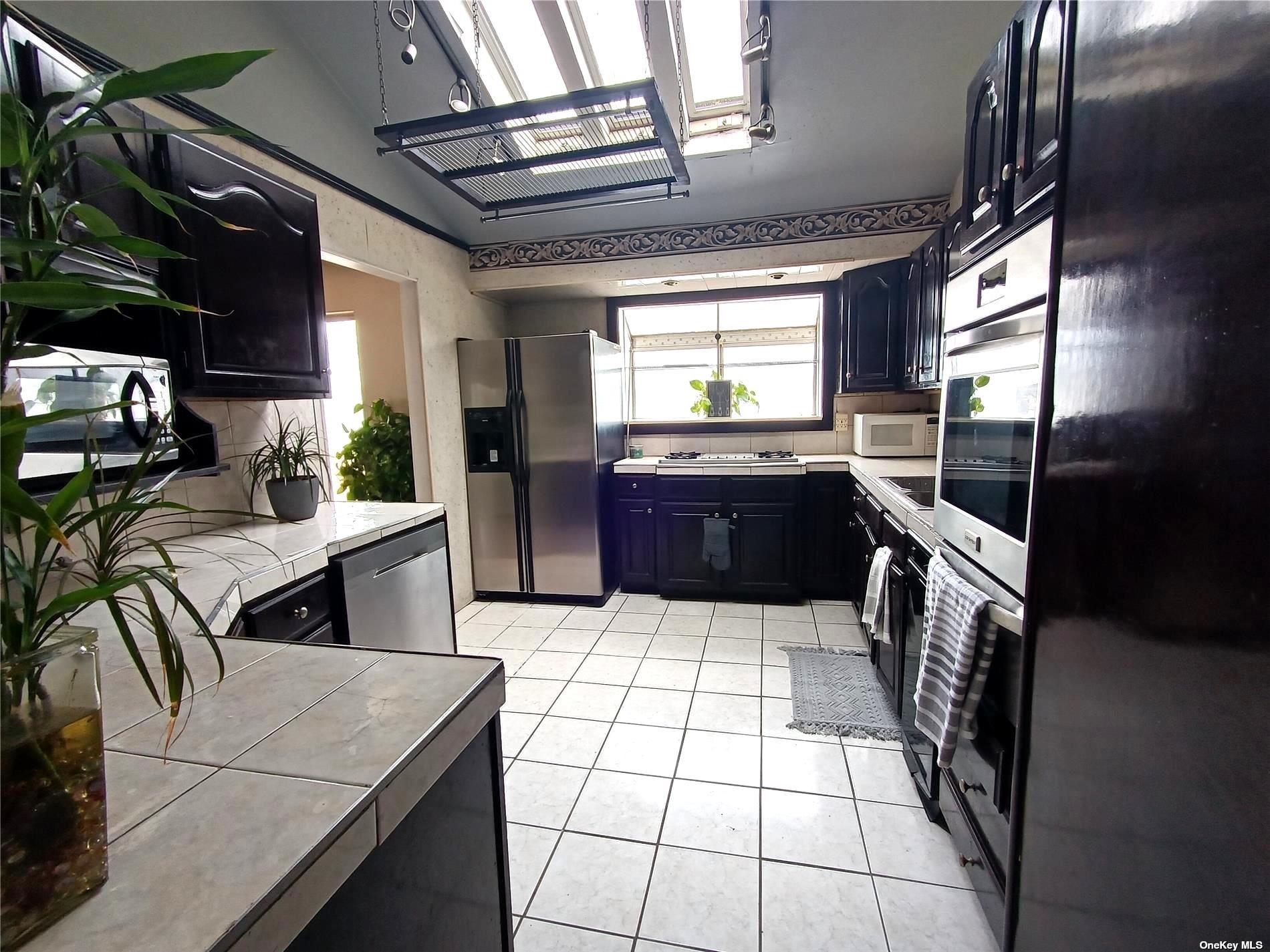 a kitchen with stainless steel appliances granite countertop sink stove and cabinets