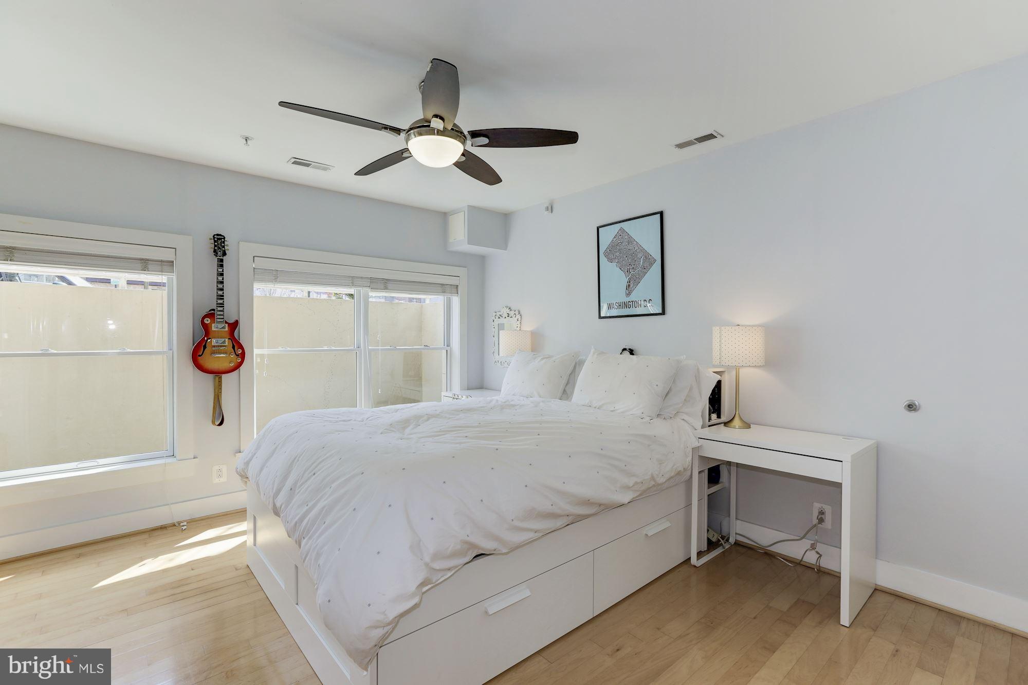 449 R Street Northwest, Unit 10 Washington, DC 20001 - Photo 13 of 23 a bedroom with a large bed and a chandelier