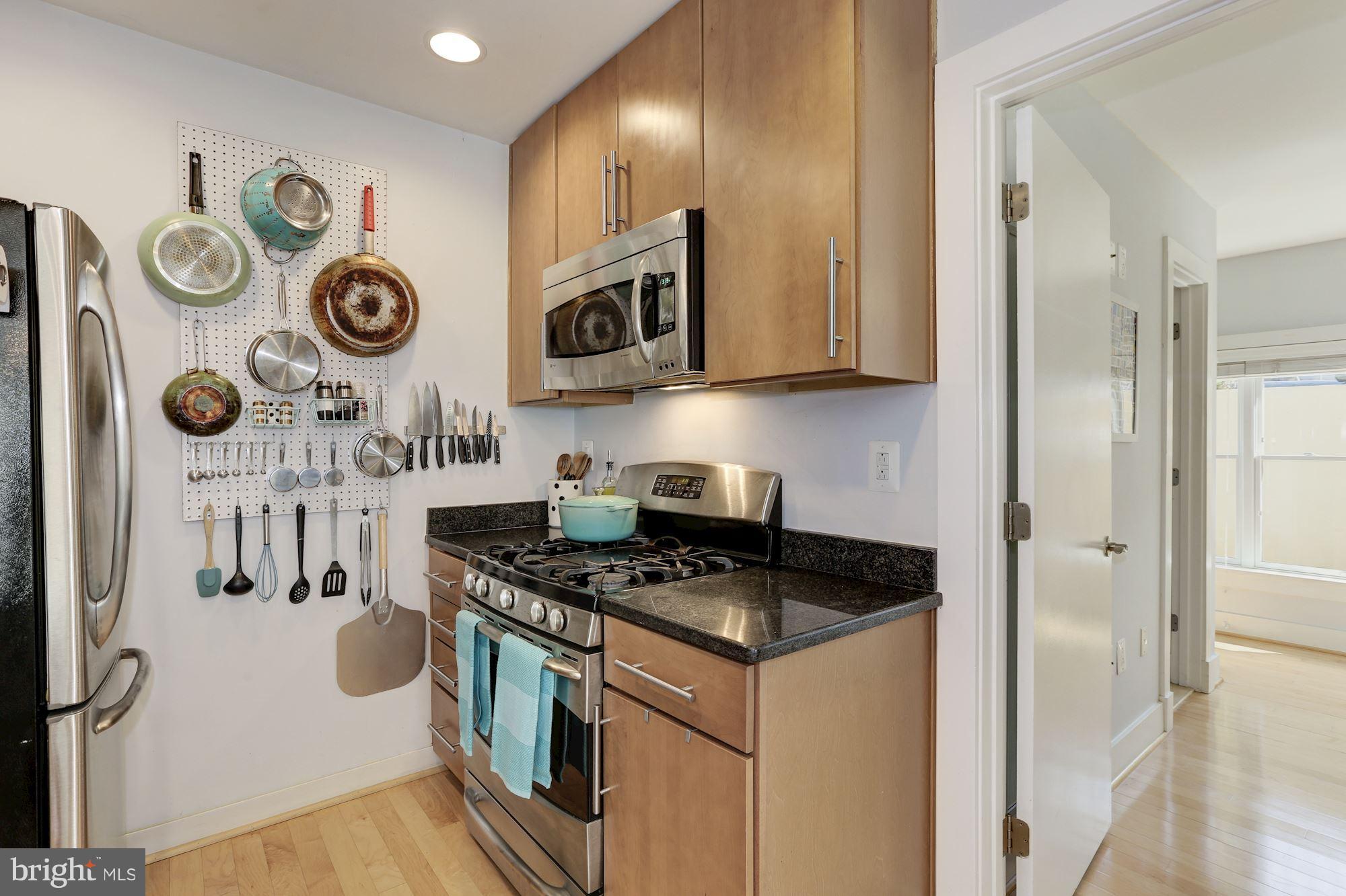 449 R Street Northwest, Unit 10 Washington, DC 20001 - Photo 10 of 23 a kitchen with stainless steel appliances granite countertop a stove and a refrigerator