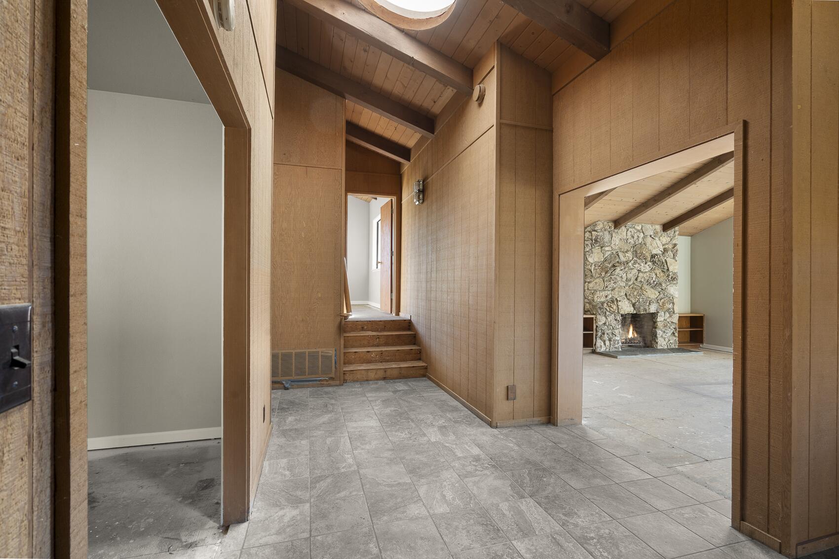 1959 Rambling Oaks Road Santa Ynez, CA 93460 - Photo 21 of 42 a view of a hallway with wooden walls and windows