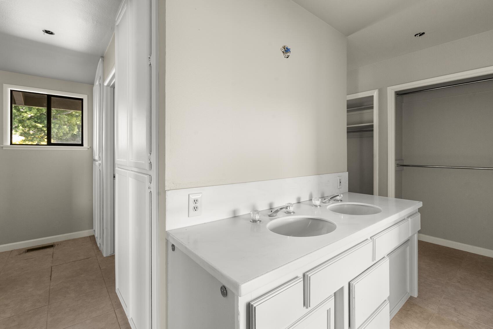 1959 Rambling Oaks Road Santa Ynez, CA 93460 - Photo 25 of 42 a bathroom with a sink and a mirror