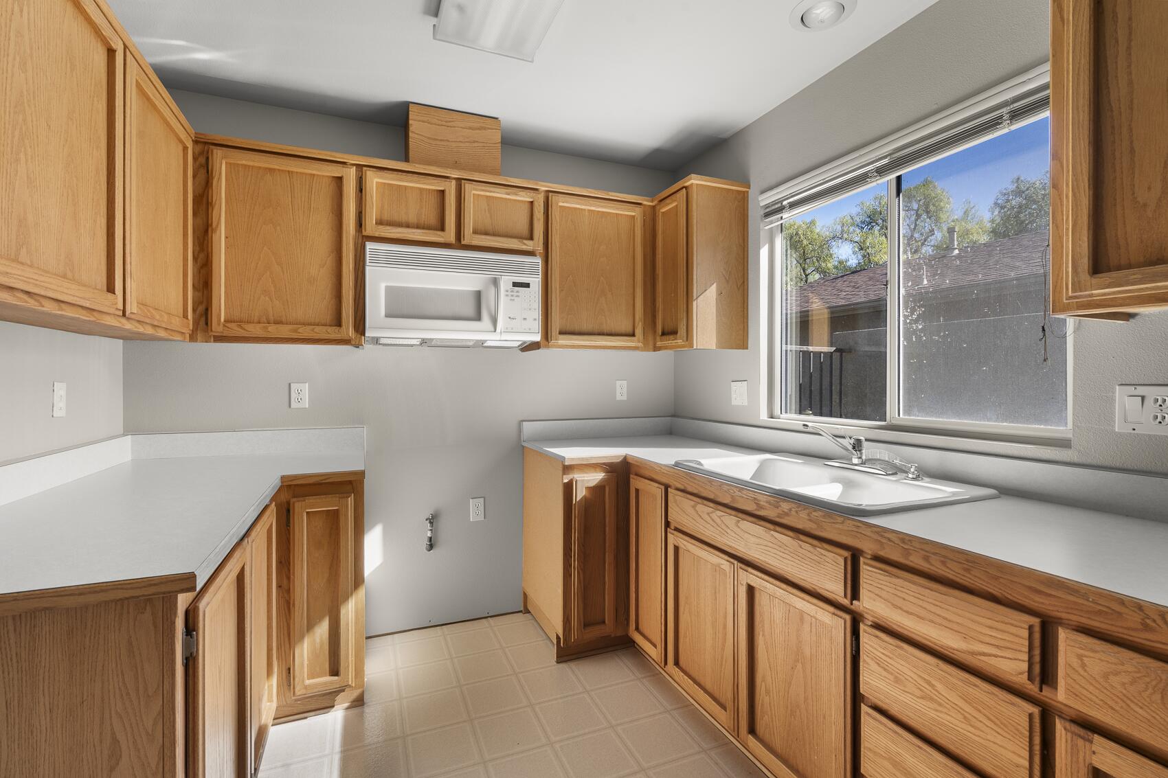 1959 Rambling Oaks Road Santa Ynez, CA 93460 - Photo 34 of 42 a kitchen with cabinets appliances and a sink