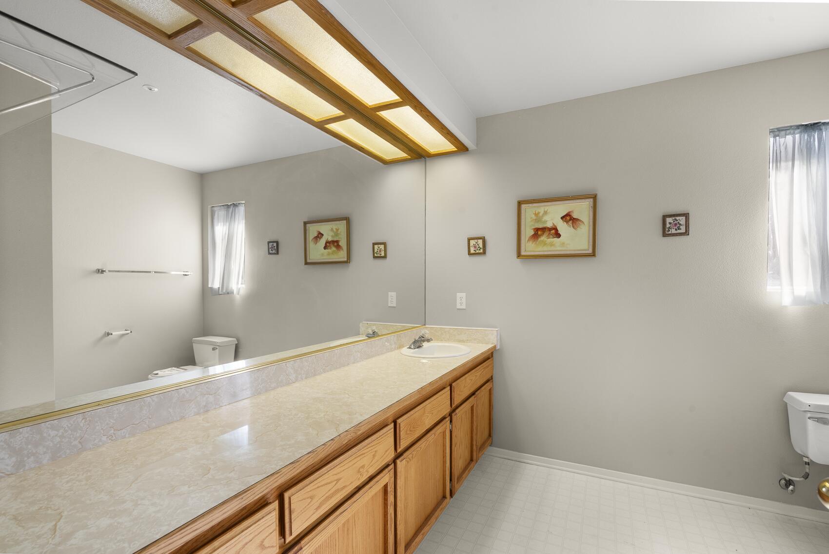 1959 Rambling Oaks Road Santa Ynez, CA 93460 - Photo 36 of 42 a bathroom with a sink and a mirror