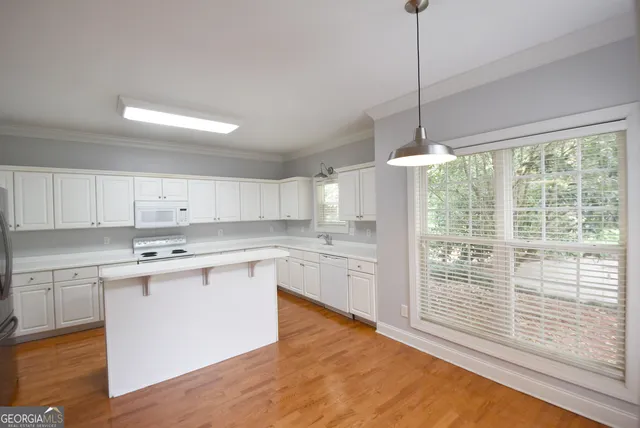 a kitchen with wooden cabinets and white appliances