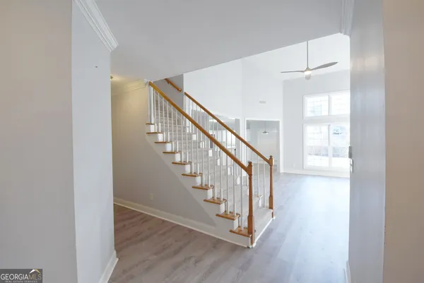 a view of entryway with wooden floor and stairs