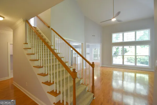 a kitchen with kitchen island a sink a stove a refrigerator and white cabinets