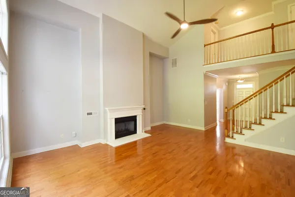 a view of a room with wooden floor and window