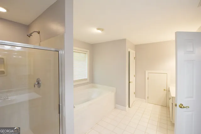 a bathroom with a shower and a glass door