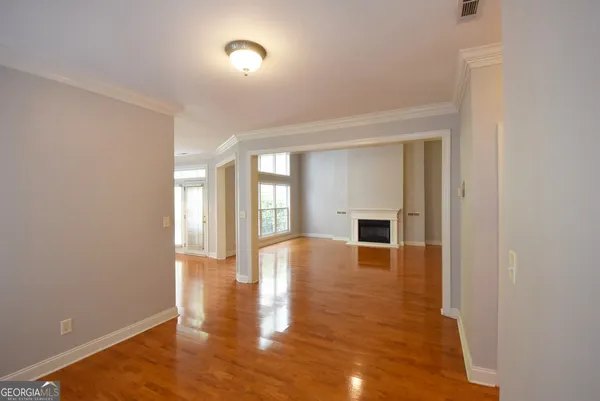 an empty room with closet and a chandelier fan