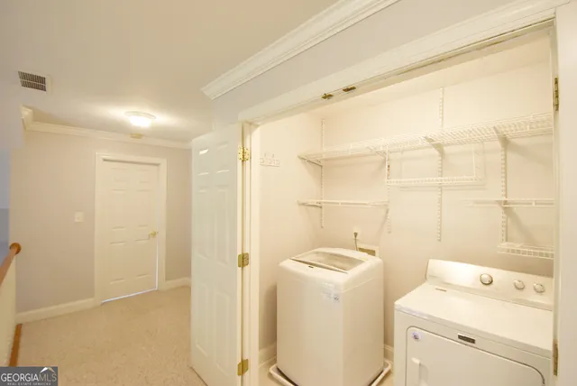 a bathroom with a sink a washer and dryer