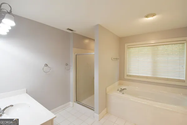 a bathroom with a sink a washer and dryer